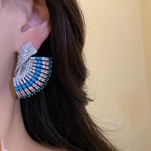Close-up of vintage geometric fan-shaped earrings with colorful sparkling stones