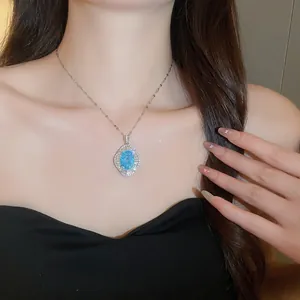 Elegant close-up of a vintage blue flower pendant necklace worn on a model's neckline