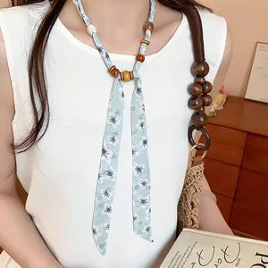Close-up detail of wood bead and daisy floral chiffon scarf necklace for women