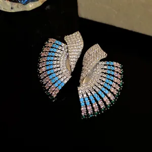 Detailed view of vintage court-style geometric earrings with colorful pave stones.