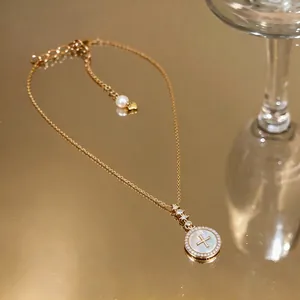 Elegant 18K gold plated necklace featuring a circular zircon pendant and pearl detail