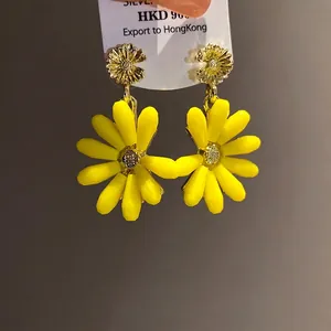 Vibrant yellow daisy flower drop earrings with gold metal finish and sparkling center