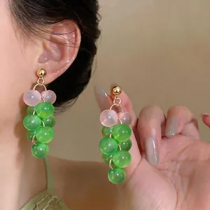 Elegant grape-shaped drop earrings featuring translucent green and pink glass beads.