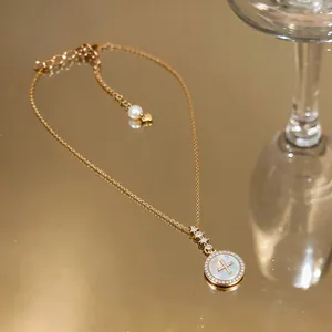 Detailed macro view of 18k gold plated round necklace with zircon and pearl accents