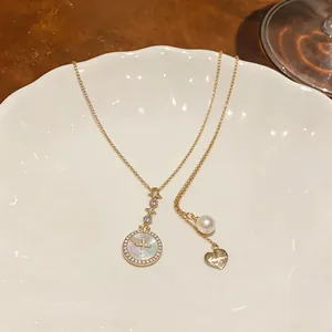 Detailed macro shot of elegant 18k gold plated necklace with pearl and zircon charms