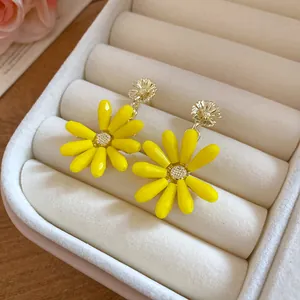 Vibrant yellow glass flower dangle earrings in a soft velvet jewelry box