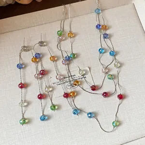 Detailed shot of colorful multifaceted glass bead tassel necklace and earring jewelry set