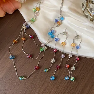 Close-up detail of multi-colored glass bead tassel necklace and earring jewelry set