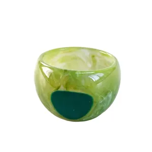 Handmade resin ring with green marble swirl pattern and emerald green inlay
