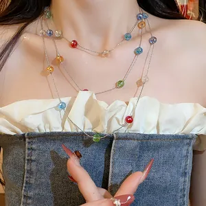 Detail view of a stylish multi-layered necklace featuring vibrant colorful glass beads