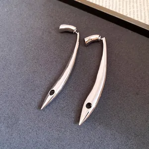 Close-up of sleek silver-tone minimalist curved drop earrings with polished finish