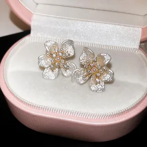Macro view of elegant French style flower earrings with pearls and zircon in a jewelry box