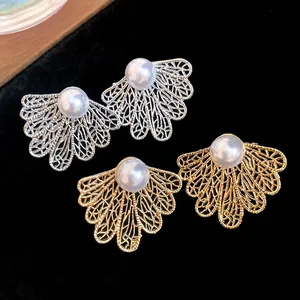 Elegant vintage pearl hollow fan leaf stud earrings in gold and silver finish.