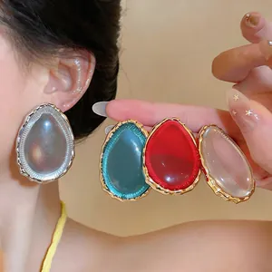 Exaggerated water-drop resin ear studs in teal, red, and clear tones for a niche look