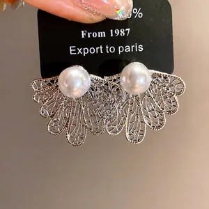 Vintage style hollow leaf silver stud earrings accented with elegant white pearls