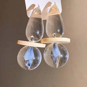 Elegant transparent resin drop earrings with retro wooden disc detail and silver needles