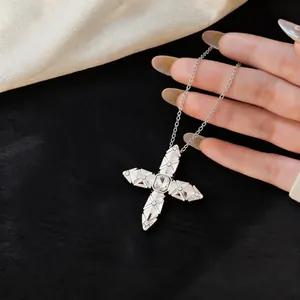 Close-up of elegant silver zircon cross star pendant necklace on black background