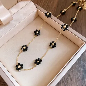 Elegante collana vintage a catena dorata con delicati fiori di perline di cristallo nero in scatola