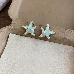 Elegant silver needle starfish stud earrings with pearl and mint shell texture for women