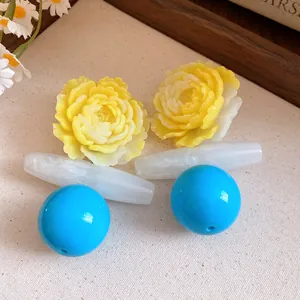Close-up view of vintage resin flower earrings with blue bead accents