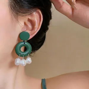Elegant dark green geometric stud earrings featuring three white baroque pearls dangle