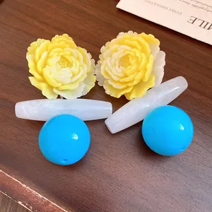 Detailed view of vintage resin flower earrings with blue spheres and white marble texture
