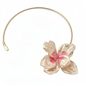 Elegant gold metal choker necklace featuring a large textured pink painted flower.