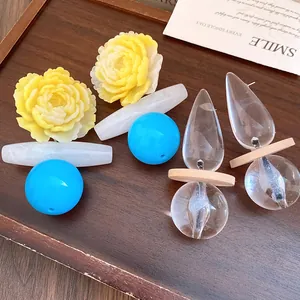 Detail view of vintage resin earrings with yellow flowers and clear glass spheres