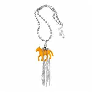 Stylish silver ball chain necklace featuring a yellow resin horse pendant with tassels