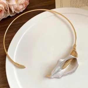 Detail view of an elegant gold choker featuring a silver-painted Calla Lily pendant