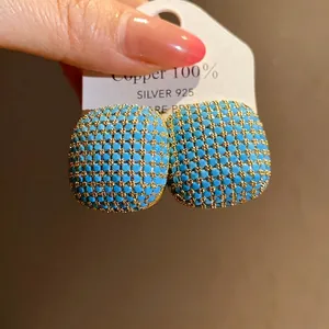 Elegant vintage square stud earrings featuring turquoise blue beads in a gold lattice setting