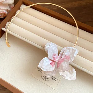 Detailed close-up of a vintage floral metal choker necklace displayed in a luxury jewelry box