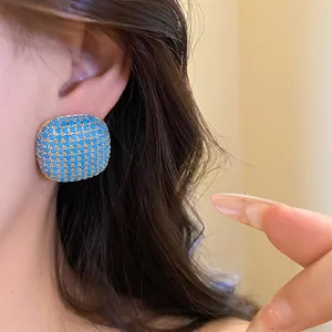 Vintage square gold-toned earrings featuring turquoise blue zircon stones in a lattice design