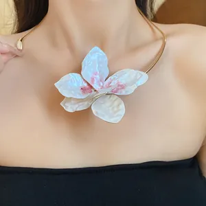Detailed view of vintage metal floral choker necklace featuring a large white flower