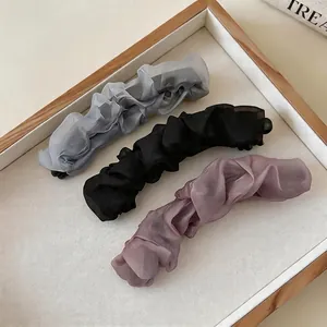 Set of three mesh ruffled banana hair clips in grey, black and dusty purple colors.