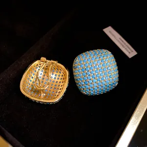Detailed view of vintage square clip-on earrings with turquoise micro beads