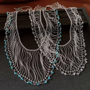 Close-up of vintage silver ball chain necklaces with blue and clear crystal bead tassels