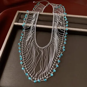 Close-up of vintage fringe necklace featuring blue crystal beads and silver tassels