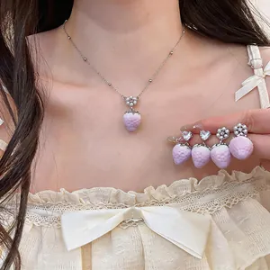 Detail of sweet pink gradient strawberry jewelry set with necklace and earrings
