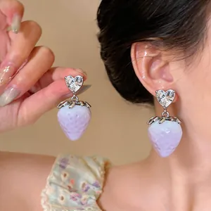 Detailed view of sweet lavender strawberry earrings with heart-shaped crystal