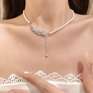 Elegant pearl necklace featuring a zircon-encrusted wing and water drop pendant