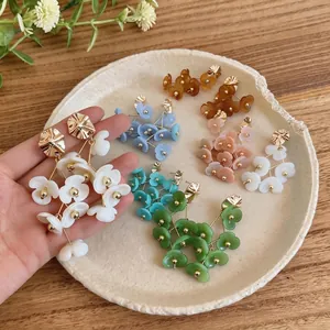 Colorful acrylic flower tassel earrings for women in bohemian vacation style.