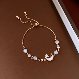 Elegant French vintage style adjustable bracelet featuring moon pendant and cat-eye stones.