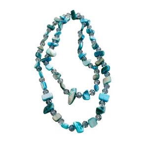 Elegant layered necklace featuring turquoise shell pieces and crystal beads.