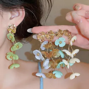 Detailed close-up shot of colorful acrylic flower tassel earrings in vibrant dopamine style