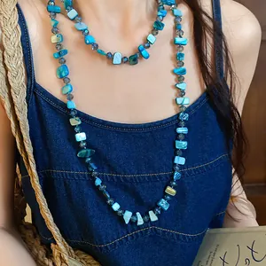 Detailed close-up view of a multi-layered necklace with square blue sea shell beads
