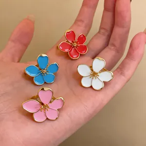 Detailed view of colorful enamel flower open rings in red, blue, white, and pink