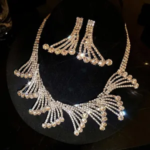 Elegant rhinestone lace cutout necklace and earring jewelry set on black velvet stand