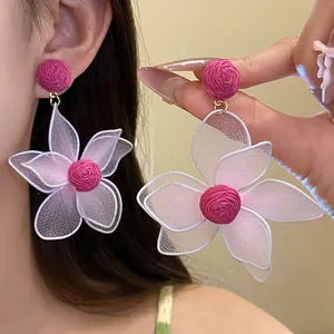 Close-up detail of elegant pink dopamine flower earrings featuring delicate mesh petals