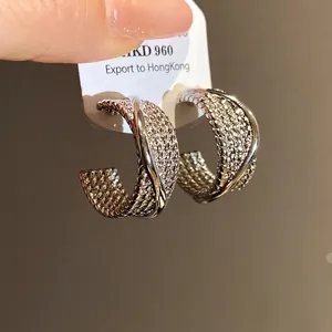Elegant textured C-shaped silver needle hoop earrings with polished crossover design
